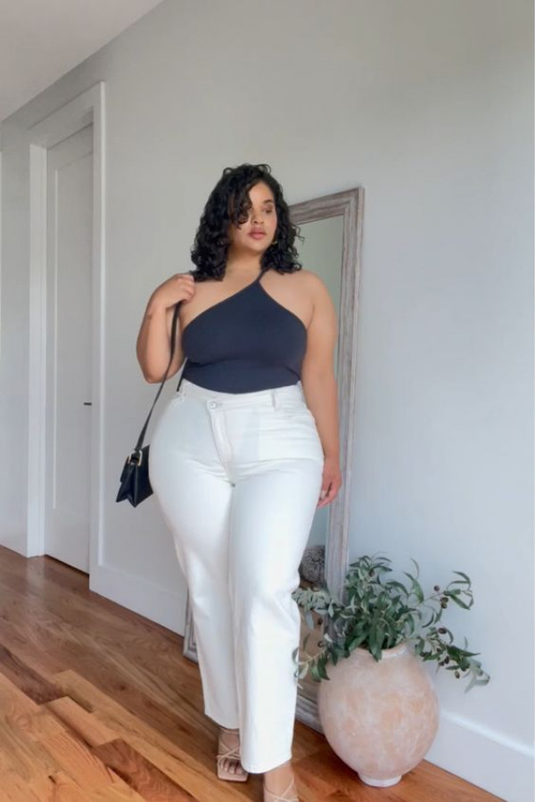 one-shoulder top and white pants for plus-size women