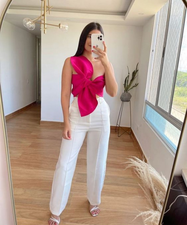 silky pink top and high-waisted white pants